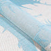 Rolled edge display emphasizes the flexible weave of Couristan Monaco Indoor/Outdoor Rug - Coastal Flora/Ivory-Turquoise