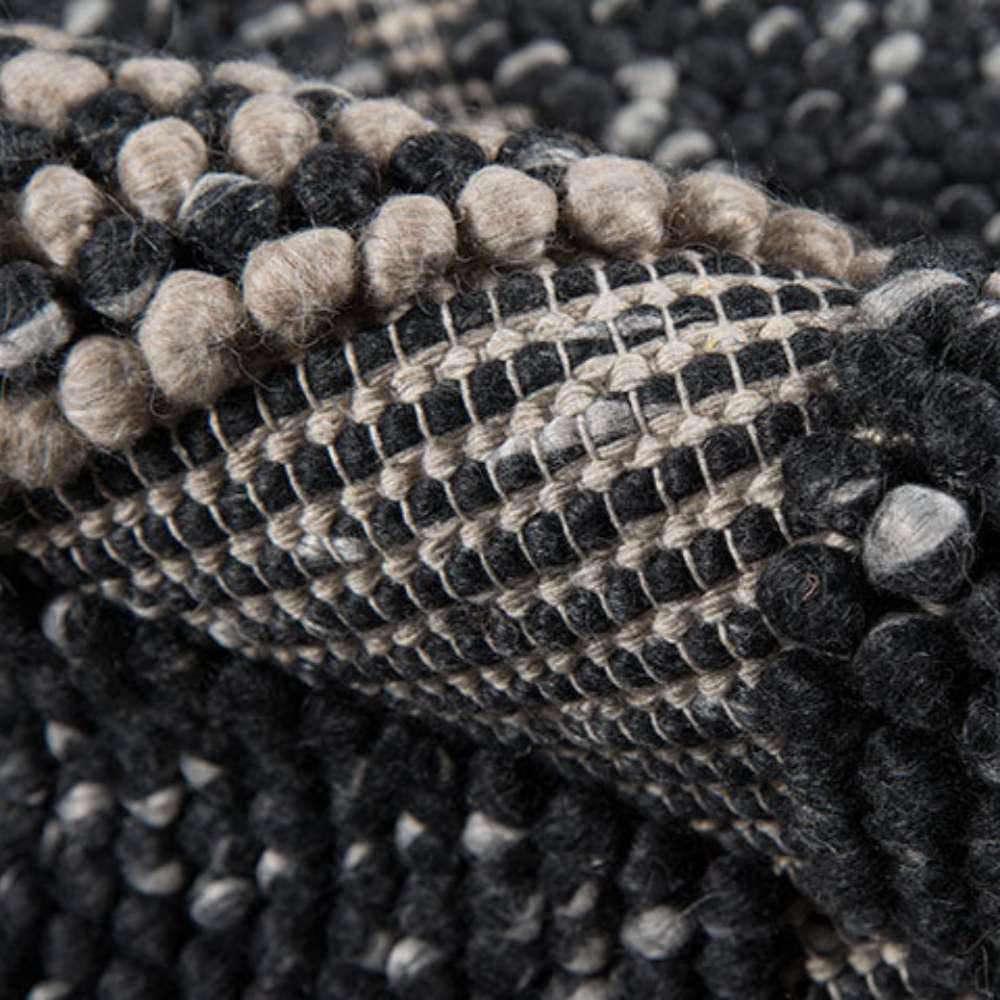 Rolled of Momeni Andes Indoor Rug - AND-1 Charcoal shows its thick, handwoven texture and durable construction