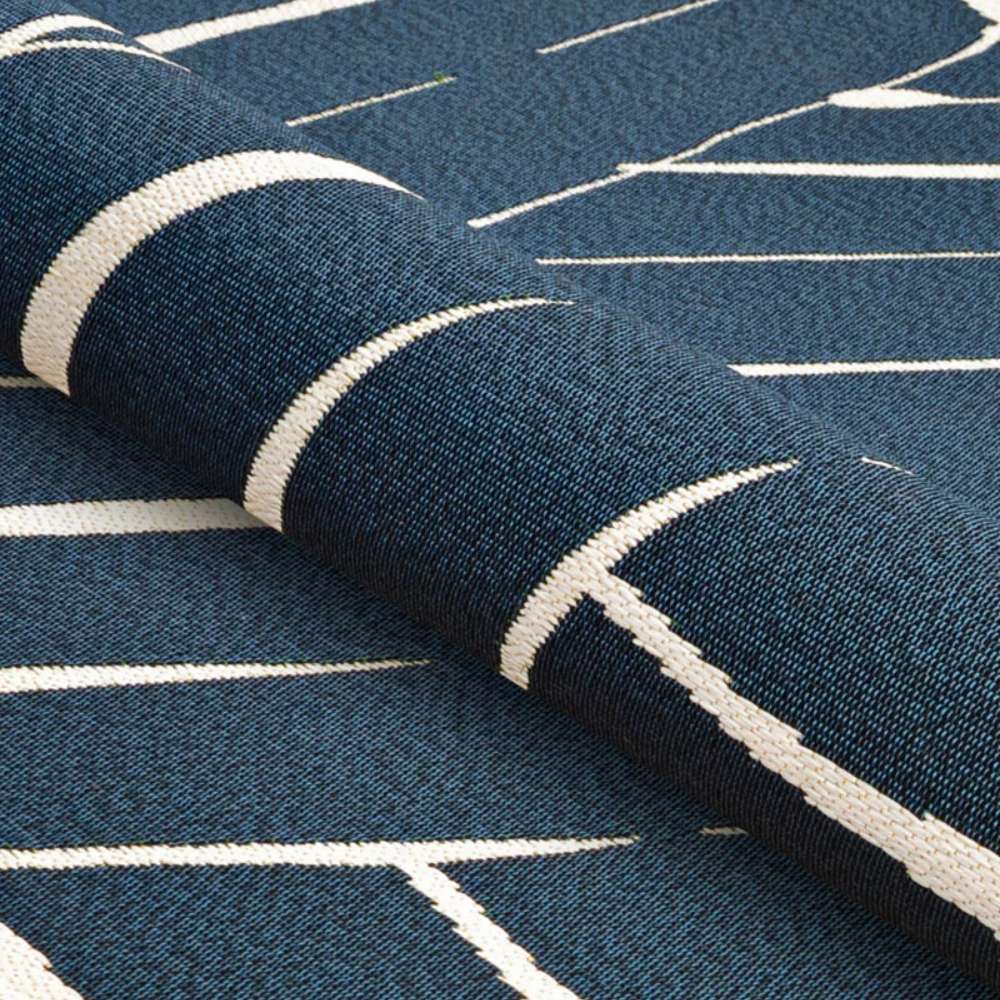 Rolled slightly at the edge, Couristan Dolce Indoor/Outdoor Rug - Parquet/Ink displays its flexibility and tight, durable weave
