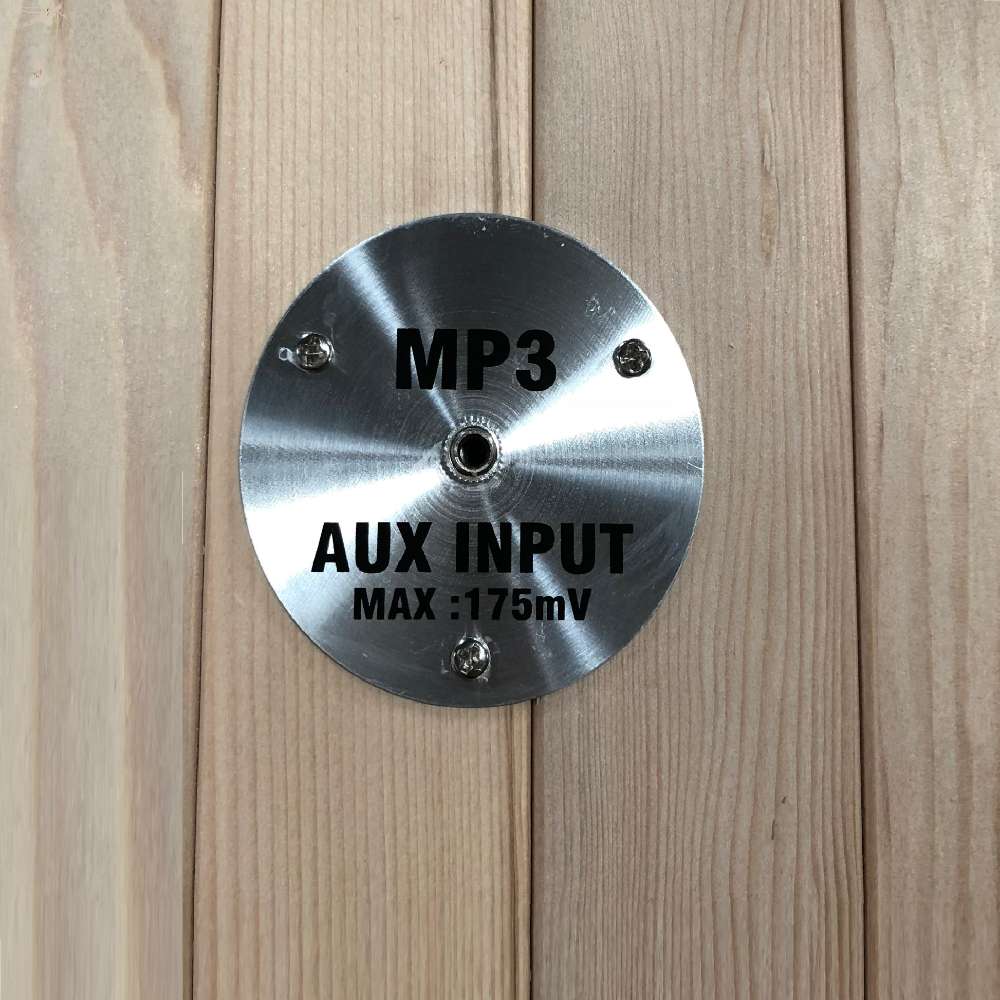 Round stainless MP3 AUX input plate mounted on the wood wall of Golden Designs Dynamic Santiago 2 Person Full Spectrum Infrared Sauna
