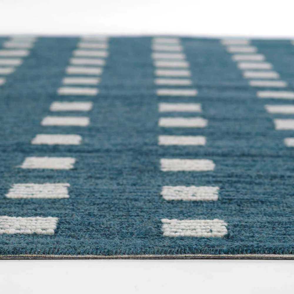 Rows of geometric white square designs stand out on the rich surface of Momeni Archer Indoor Rug - ARC-1 Blue