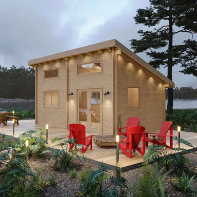 Rront view of the completed Sawmill Structures The Versa 240 70MM Garden Room with large windows, outdoor lighting, and a fire pit seating area
