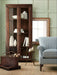 Rustic Crate & Barrel Morris 36" Chocolate Brown Wood and Glass Bookcase Cabinet styled with décor beside a striped armchair