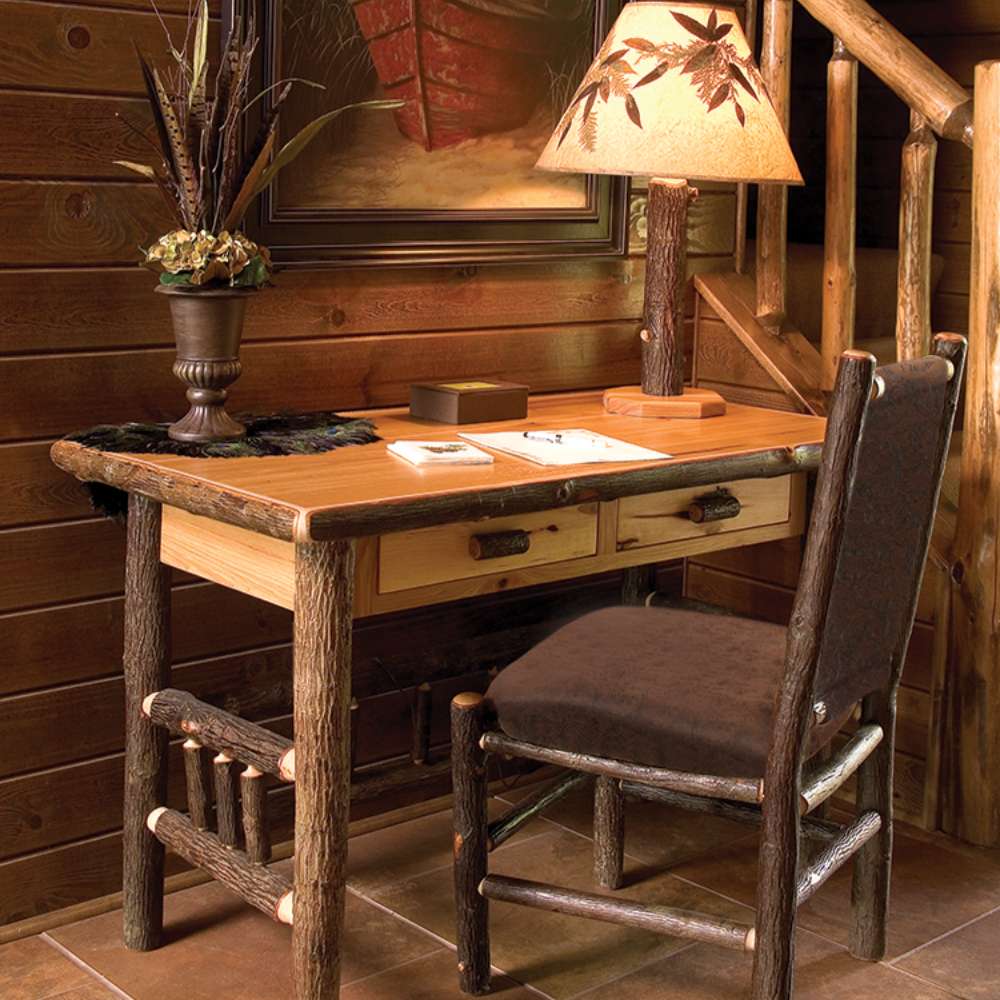 Rustic cabin-style desk with log legs and two drawers, known as the Fireside Lodge Hickory Log Two Drawer Writing Desk