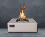 Sand Pebble Warming Trends AON Steel Square Fire Pit Table is lit with bright flames over its brass burner