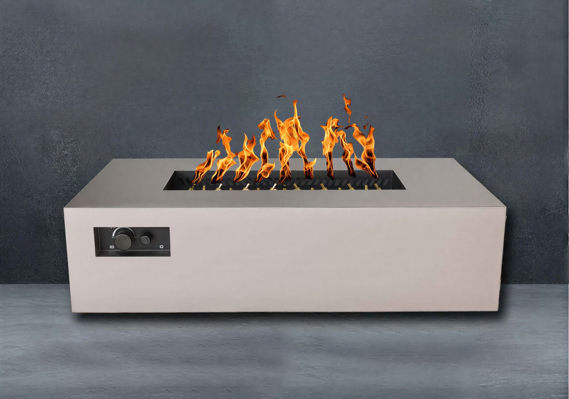 Sand Pebble Warming Trends AON Steel Rectangular Fire Pit Table burns warmly in an outdoor setting with a smooth, modern finish