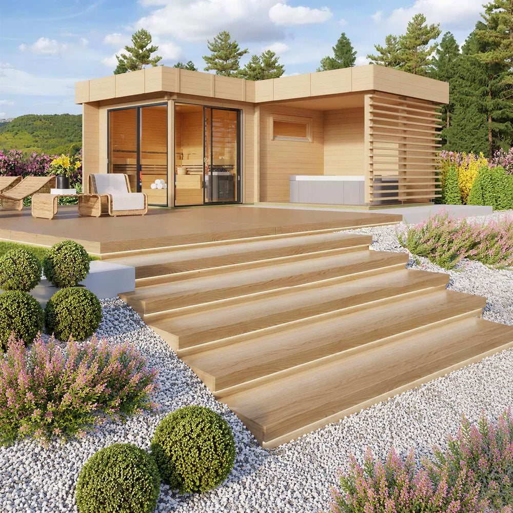 A landscaped deck setup with lounge chairs in front of the GardenHouse24 USA Sauna Forte 70 Garden Room