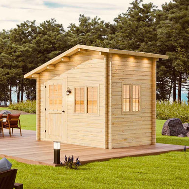 Sawmill Structures Bluewater Den 67 Garden Room placed on a wooden platform outdoors, surrounded by grass, trees, and patio furniture