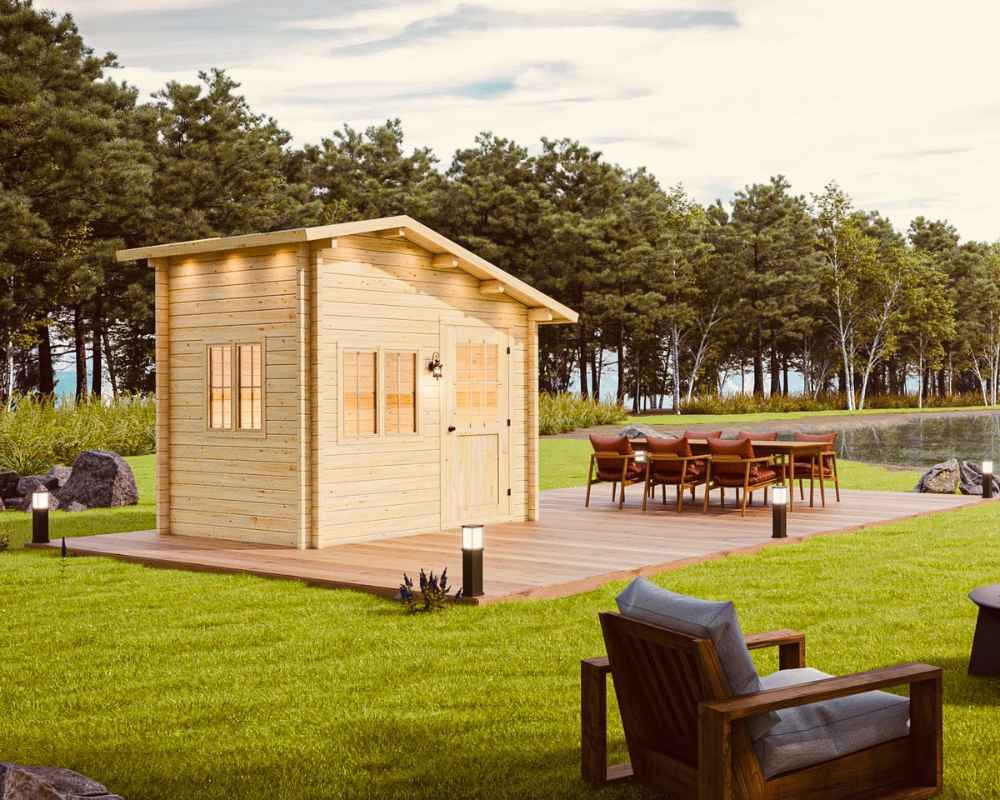 Sawmill Structures Bluewater Den 67 Garden Room with a nearby outdoor dining setup beside a pond and tall trees