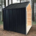 Sawmill Structures CabinSauna placed among forest trees, blending its black metal and wood exterior
