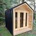 Sawmill Structures CabinSauna set in a green forest area, combining rustic wood with sleek black metal
