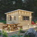 Sawmill Structures Eze Breeze Sunroom Cabin showcases its natural wood design, slanted roof, and scenic forest surroundings