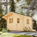 Sawmill Structures Harvest Grand Bungalow 107 Garden Room, highlighting its compact log cabin design nestled in a forest setting