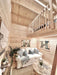Sawmill Structures Ontario Grand Loft 107 SD Garden Room showcases its double-height living room with a view of the loft bed and white sofa below