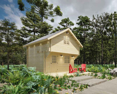 Sawmill Structures Ontario Grand Loft 107 SD Garden Room stands in a forest clearing with red chairs on its patio and tall trees in the background