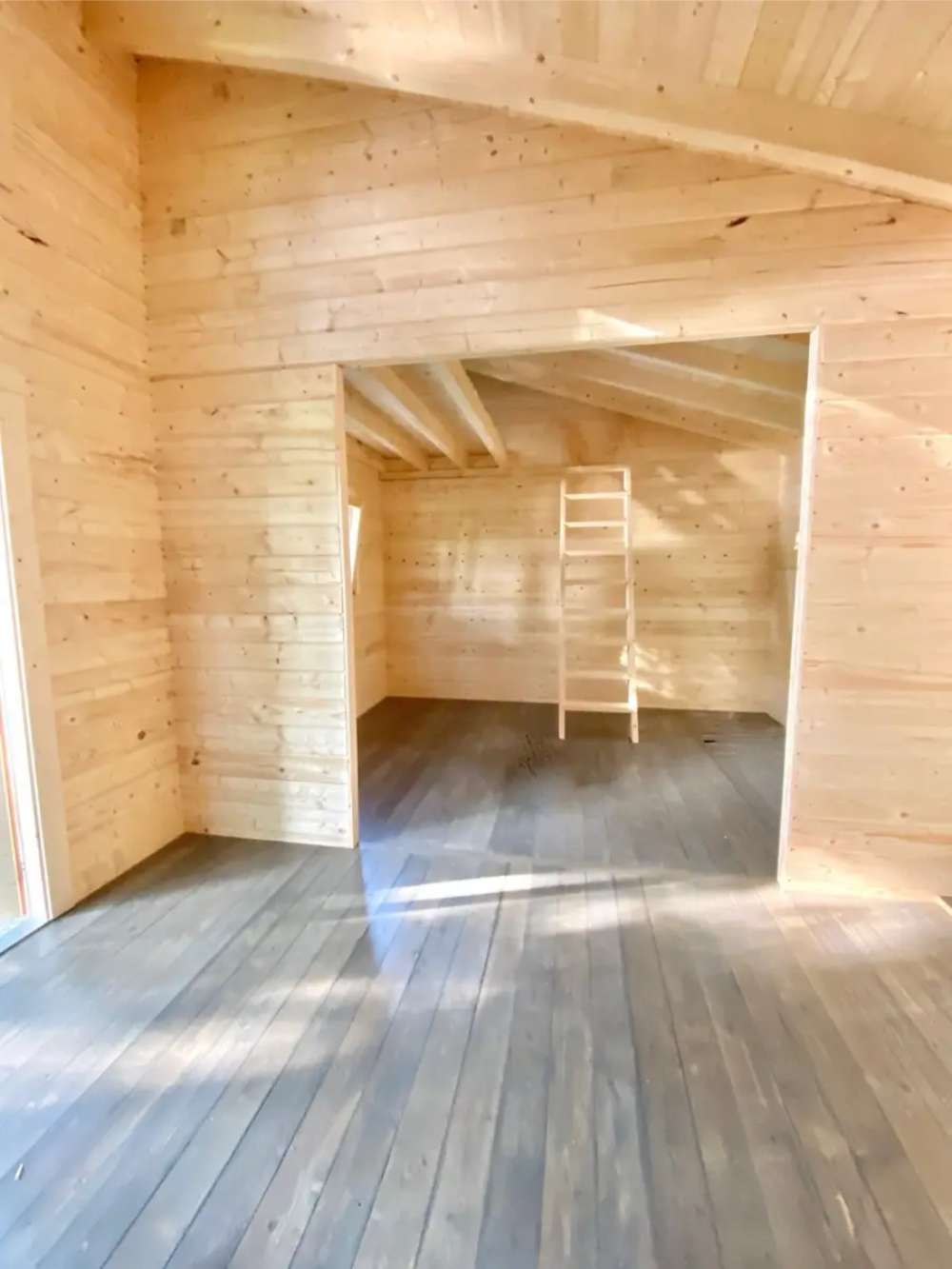 Sawmill Structures The Versa 240 70MM Garden Room appears empty and sunlit