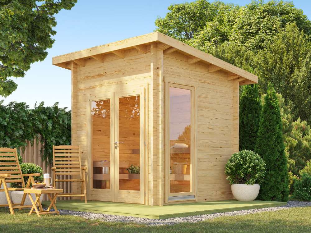 Sawmill Structures Versa Sauna sits in a cozy backyard corner with wooden chairs nearby