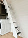 Sawmill Structures Wanderlove Tiny Home includes a compact white staircase with dark step grips and a washer-dryer