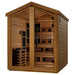 Seen from the front right, Golden Designs Kaskinen 6 Person Barn Hybrid Outdoor Sauna shows its glass double doors, a guarded stove and infrared heaters along the benches