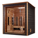 Seen from the front right, Golden Designs Visby 3 Person Outdoor-Indoor PureTech Hybrid Full Spectrum Sauna shows a dark gray side wall, cedar trim and a guarded stove behind the glass