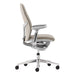 Seen from the side, Crate & Barrel Haworth Zody Upholstered Stone Office Chair displays its slim silhouette, ergonomic backrest, and five-wheel base