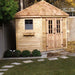 Seen from an angle, the Outdoor Living Today 9×9 Penthouse Garden Shed displays its classic side window and charming cedar finish