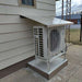 Senville Large Outdoor Ground Stand/Bracket for Mini Split (18000-36000 BTU) installed beneath an overhang to keep the outdoor condenser elevated above the concrete pad