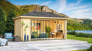 Set in a scenic lakeside environment, the GardenHouse24 USA Pavilion ALU 44D Garden Room is styled as a cozy and artistic workspace