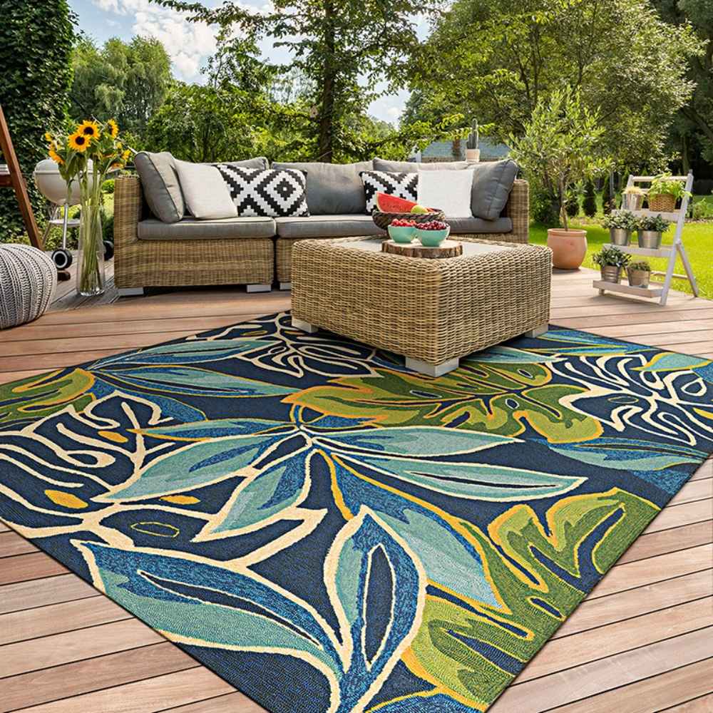 Set in a bright outdoor patio, the Couristan Covington Indoor/Outdoor Rug - Areca Palms/Brown-Forest Green adds vivid color and botanical flair beneath wicker furniture