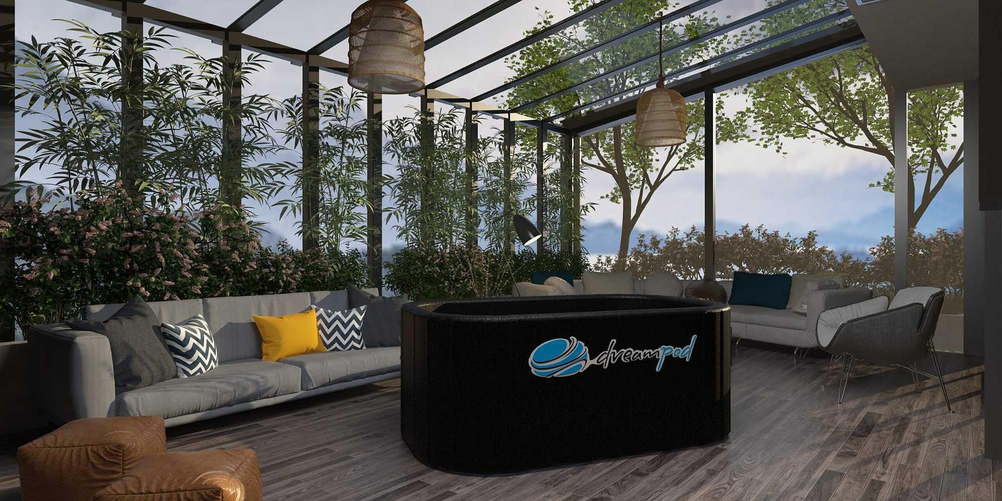 Set indoors, the Dreampod Ice Bath FLEX is surrounded by cozy sofas, plants, and natural light filtering through large windows