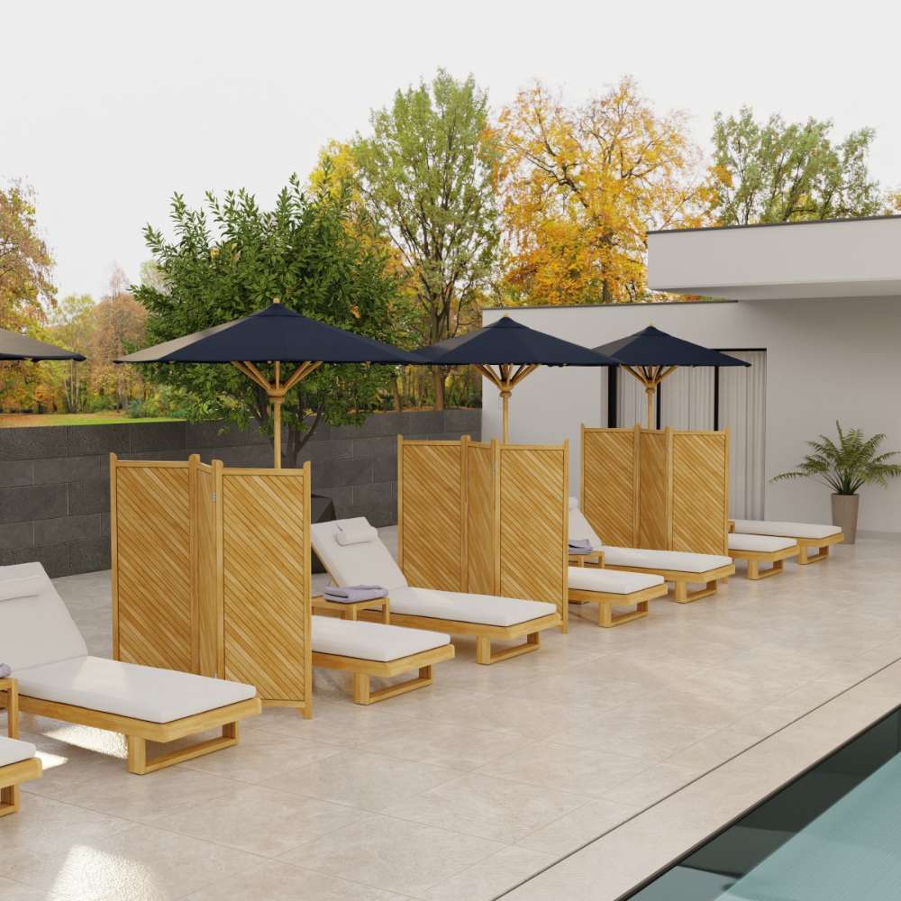 Several Westminster Teak Horizon Chaise Lounger chairs are arranged in a neat row beside a modern pool, each with cushions and shaded by umbrellas and privacy panels