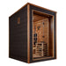 Side angle of Golden Designs Nora 2 Person Outdoor-Indoor PureTech Hybrid Full Spectrum Sauna showing its dark wall, glass corner and the guarded stove inside