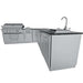 Side angle of Sunstone Rancher L-Shaped 8′11″ × 11′ Outdoor Kitchen Package showing grill, sink, and storage cabinets