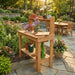 Side angle shows a potting bench in a landscaped backyard with flowers, with Outdoor Living Today 4×2 Western Red Cedar Potting Bench at the center