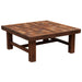Side-angle view of Fireside Lodge Barnwood Americana Coffee Table - 42 Inch emphasizing its thick tabletop, solid wooden legs, and warm rustic charm