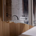 Side label on the stainless Harvia stove of Golden Designs Copenhagen 3 Person Traditional Sauna showing a printed spec chart, a timer dial and The Wall logo