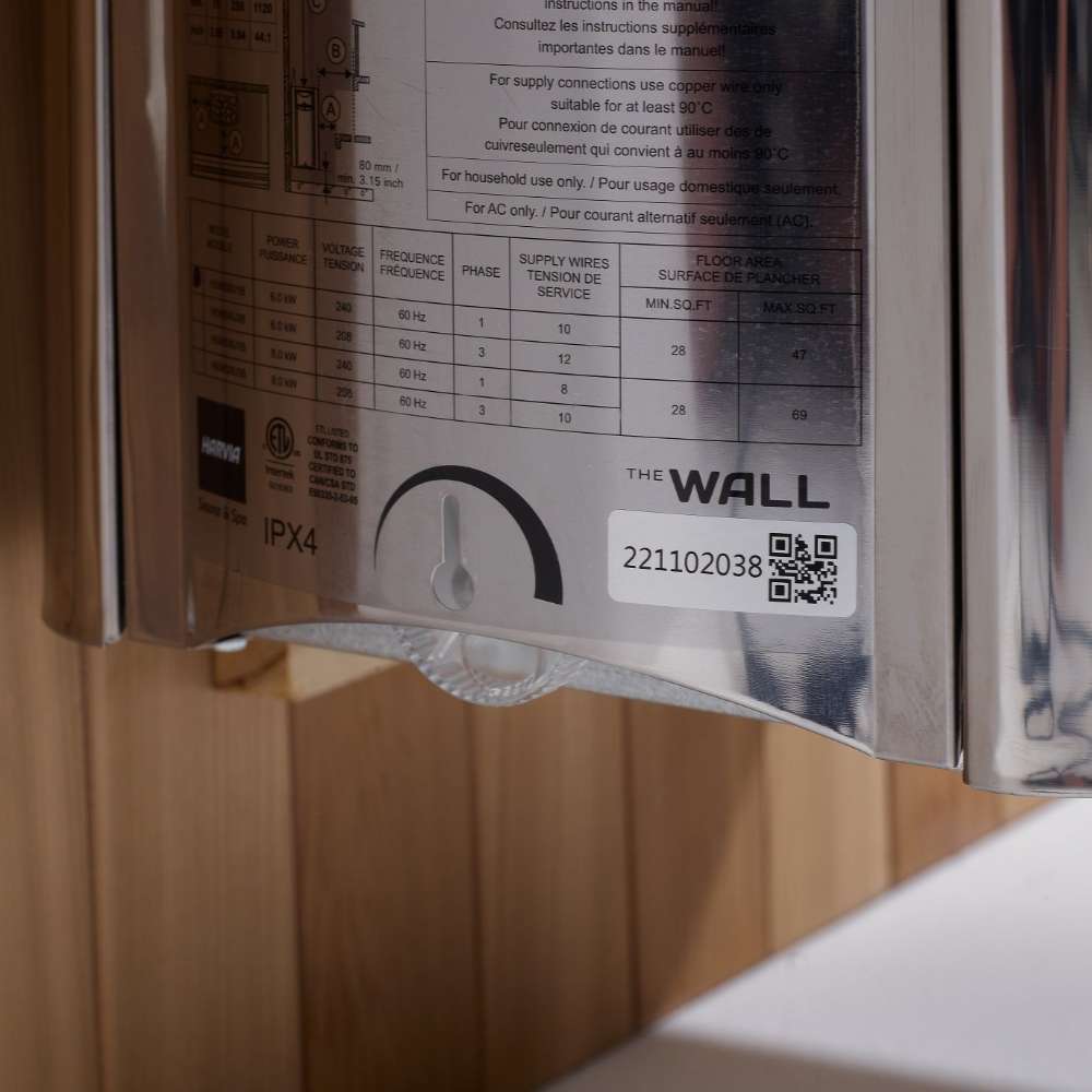 Side label on the stainless Harvia stove of Golden Designs Gargellen 5 Person Hybrid Outdoor Sauna showing a printed spec chart, a timer dial and The Wall logo