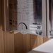 Side label on the stainless Harvia stove of Golden Designs Gargellen 5 Person Hybrid Outdoor Sauna showing a printed spec chart, a timer dial and The Wall logo
