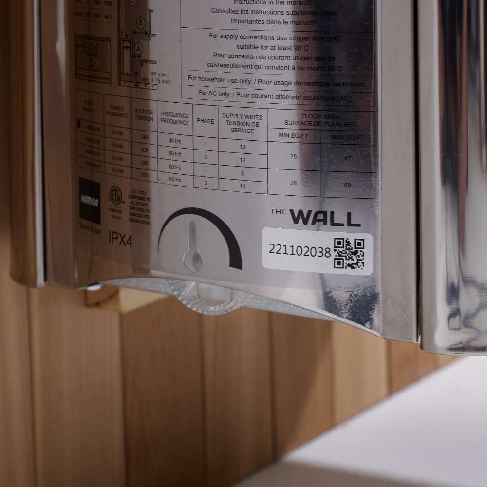 Side label on the stainless Harvia stove of Golden Designs Klosters 6 Person Barrel Traditional Sauna showing a printed spec chart, a timer dial and The Wall logo