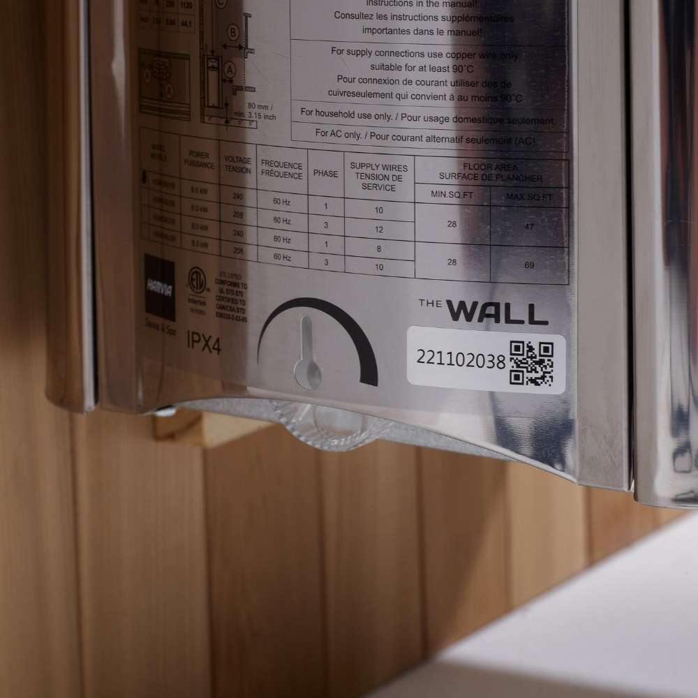 Side label on the stainless Harvia stove of Golden Designs Sundsvall 2 Person Traditional Sauna showing a printed spec chart, a timer dial and The Wall logo