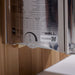 Side label on the stainless stove of Golden Designs Forssa 3-4 Person Traditional Sauna showing a printed spec chart, a timer dial and The Wall logo