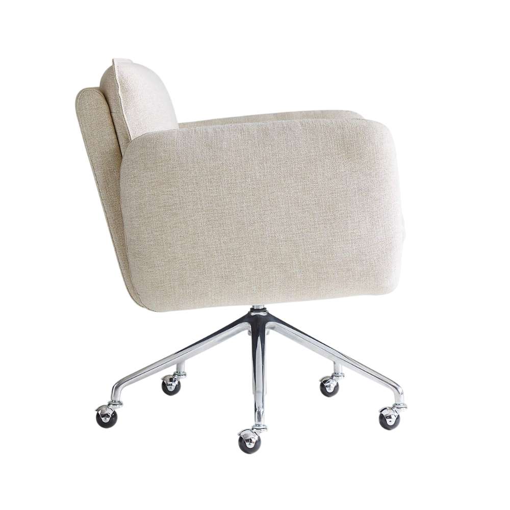 Side profile of Crate & Barrel Jens Plush Ivory Office Chair highlighting its curved silhouette, plush upholstery, and caster-equipped swivel base