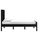 Side profile of Crate & Barrel Keane Black Solid Wood Queen Bed showing the full-length black wood frame and tall headboard