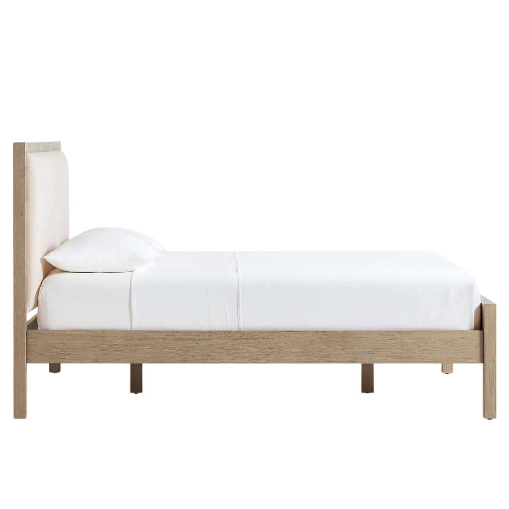 Side profile of Crate & Barrel Keane Weathered Natural Wood Upholstered Queen Bed showing its upholstered headboard, footboard, and sturdy wood frame