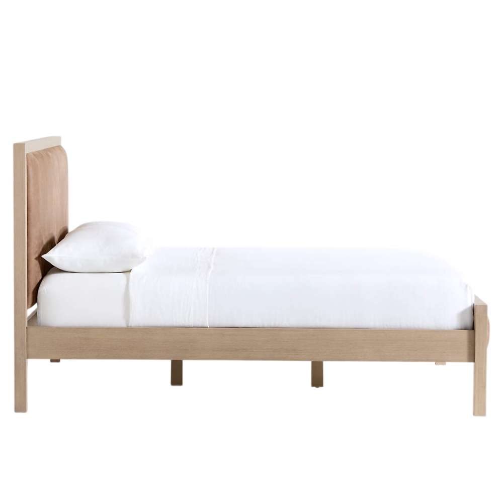 Side profile of Crate & Barrel Keane Weathered Natural Wood and Leather Queen Bed showing its leather headboard, footboard, and sturdy wood frame