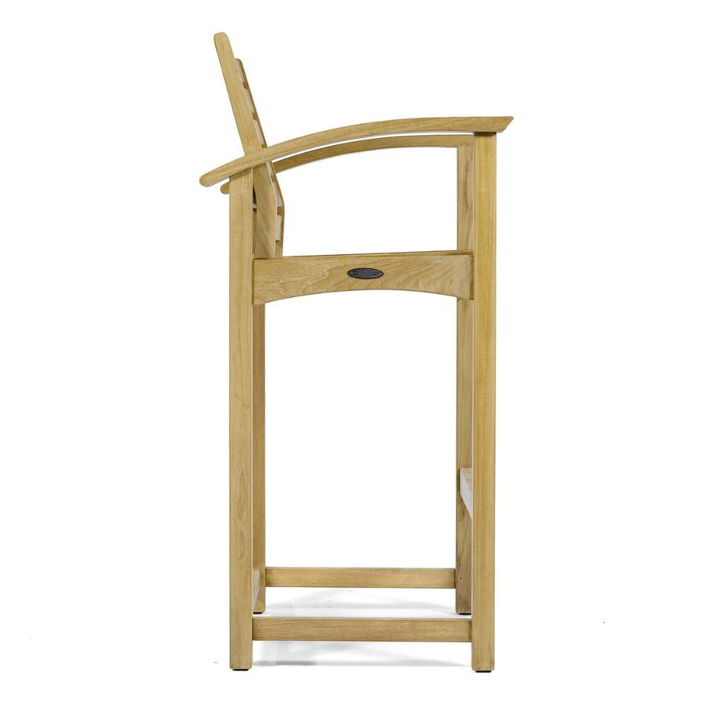 Side profile view of Westminster Teak Somerset Teak Bar Stool shows its tall legs, footrest, and gently curved armrests on a plain white background
