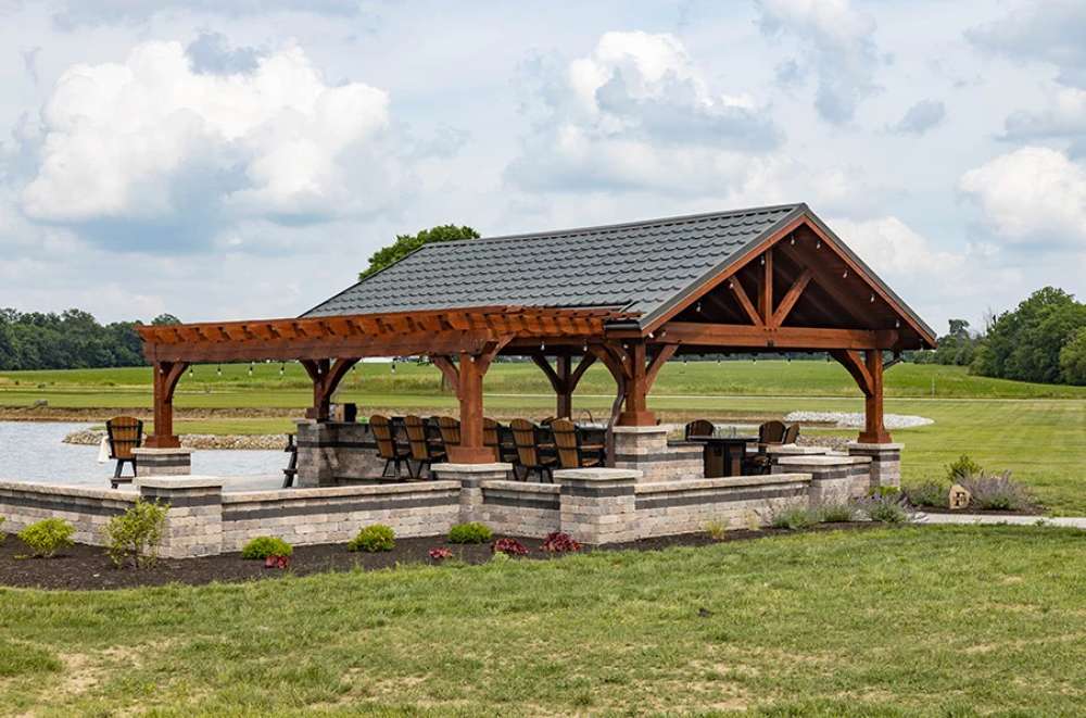 Side view of Brookside Timber Frame Combolan Estate Pavilion showcases its durable wood and stone construction
