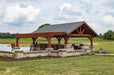 Side view of Brookside Timber Frame Combolan Estate Pavilion showcases its durable wood and stone construction