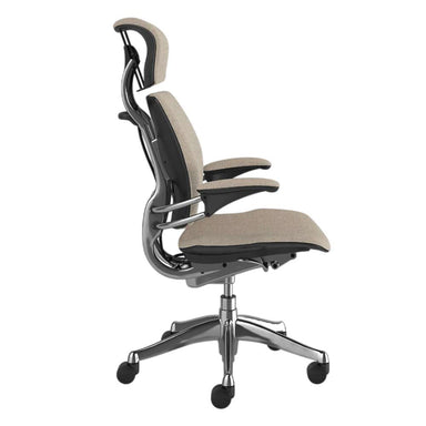 Side view of Crate & Barrel Humanscale® Freedom Headrest Natural Linen Office Chair with padded headrest, armrests, and chrome wheeled base