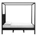Side view of Crate & Barrel Keane Black Solid Wood King Canopy Bed shows the tall canopy frame, solid headboard, and low-profile platform base
